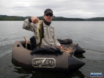 Warren with a bass caught on fly